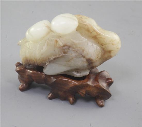 A Chinese white and brown jade figure of a recumbent of crane, Song dynasty or later, length 5cm, wood stand